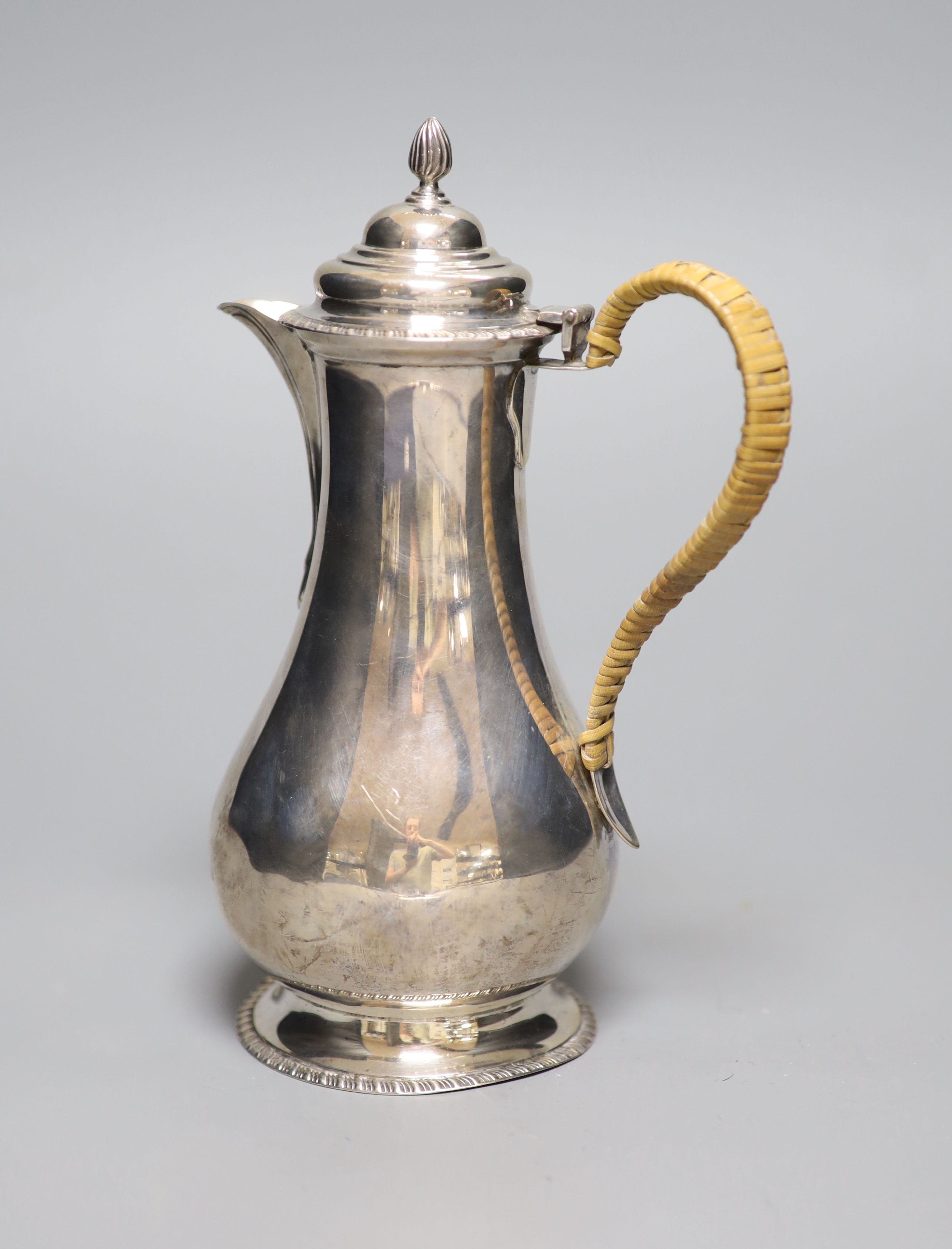 A George V silver hot water pot with rattan handle, London, 1919